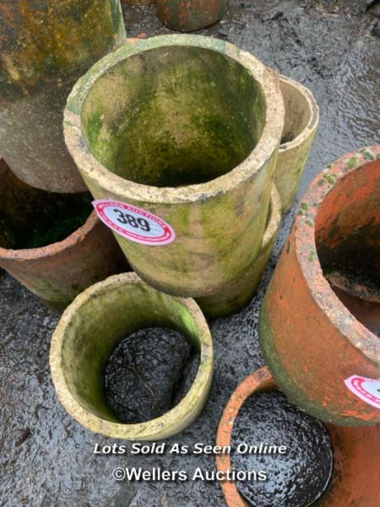 A SET OF FOUR TERRACOTTA CHIMNEY POTS, 31CM (H)