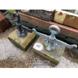 TWO MATCHING CAST IRON FOOT SCRAPERS ON STONE BASES