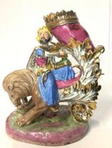 A large Turkish porcelain figure of a Sultan holding a cornucopia upon a lion, 34 x 24cm / AN37