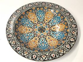 A large colourful hand painted glazed plate, 36cm diameter / AN3