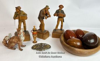 Three wooden figures of musicians, four wooden eggs in a bowl, miniature wooden pot with lid,