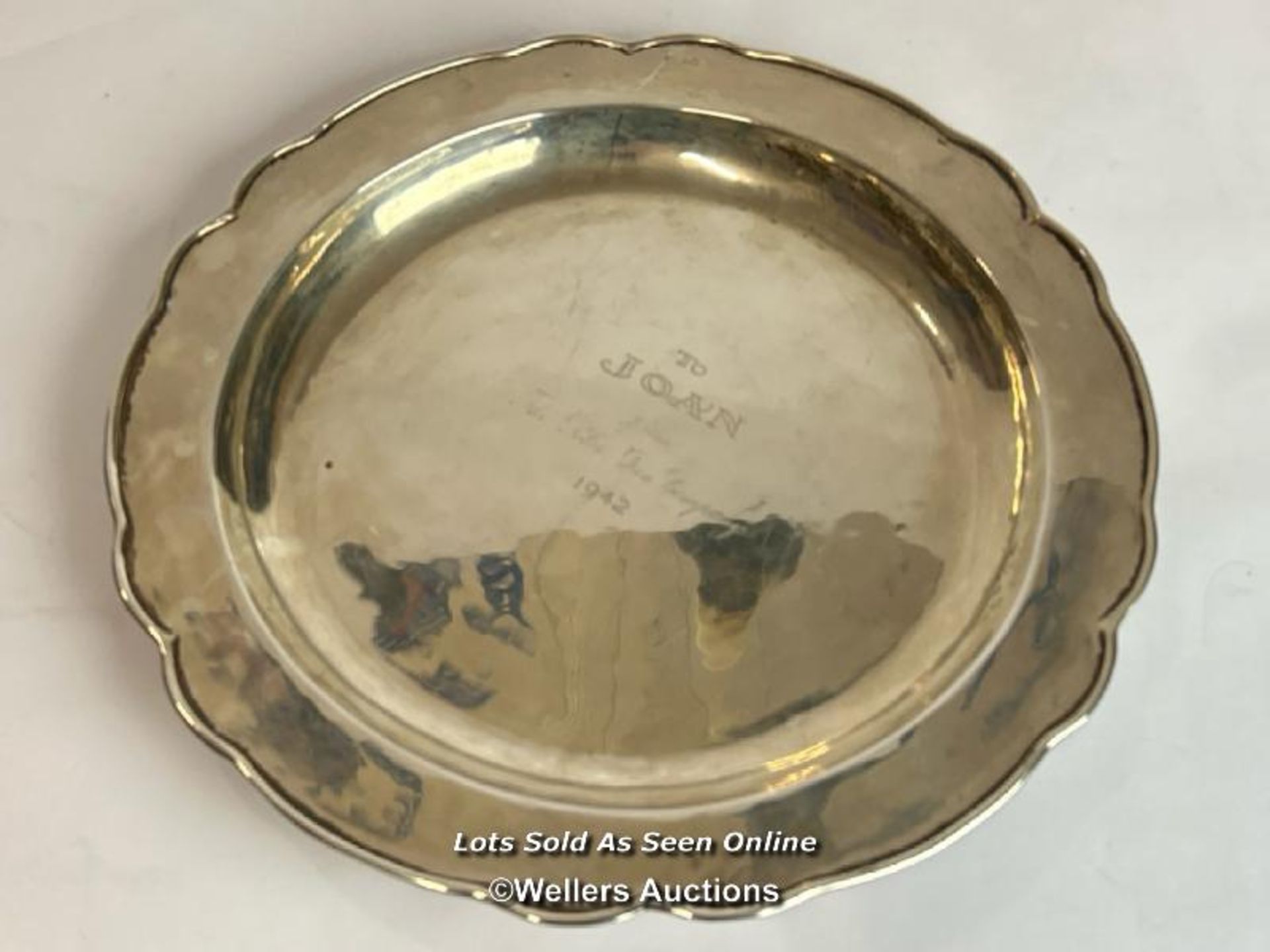 A white metal plate by Hecho Amano stamped 0900 and engraved "To Joan from the Peter Pan Company