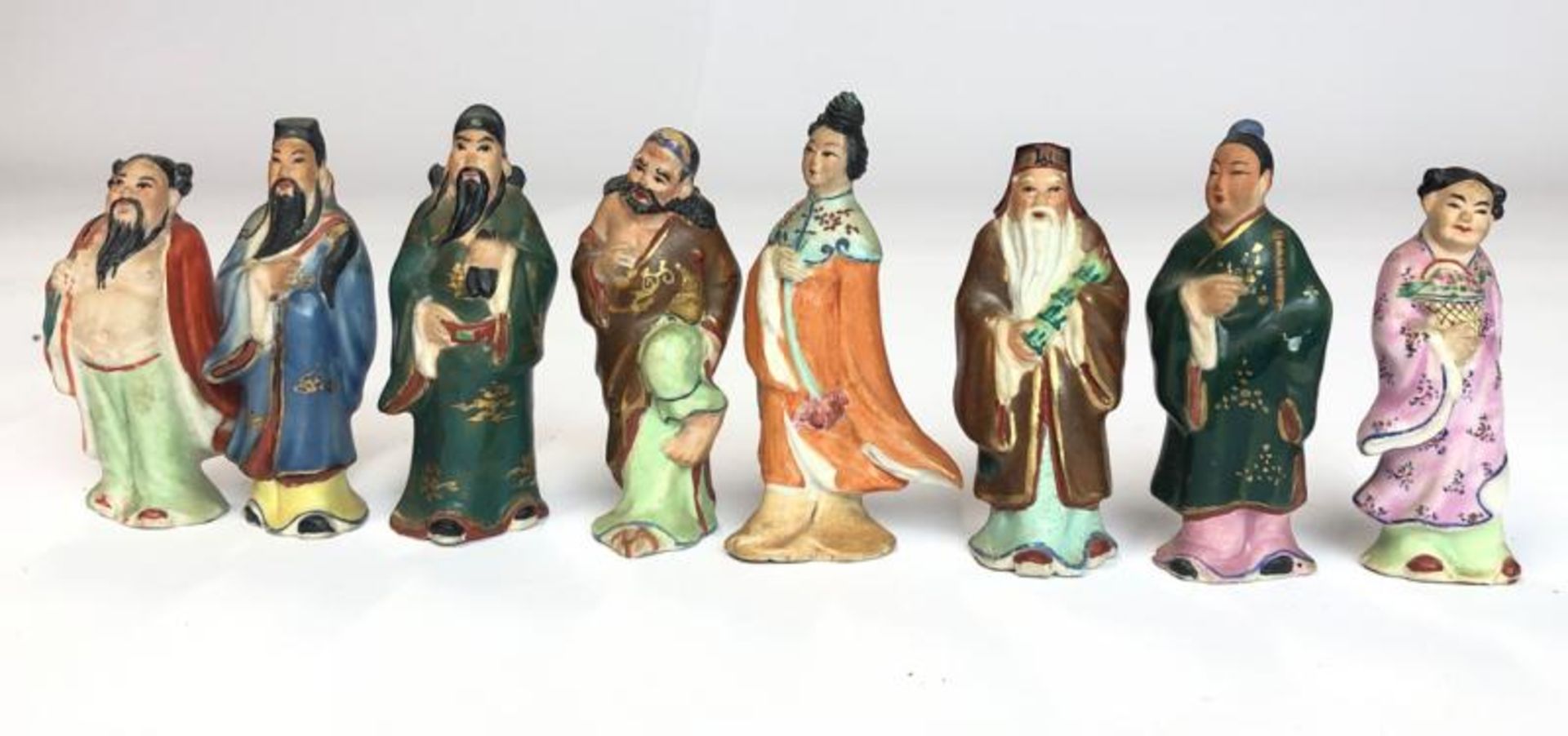 Eight Chinese miniature hand painted figurines representing the eight immortals, tallest 7cm