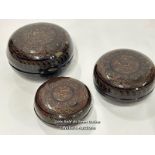 A decorative lacquer ware set of three round boxes, largest 15cm diameter / AN14