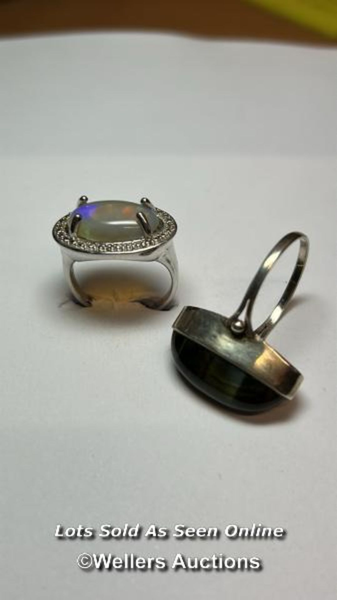 An opel ring in white metal stamped 925 for silver, ring size Q, and a chrysoberyl ring in white
