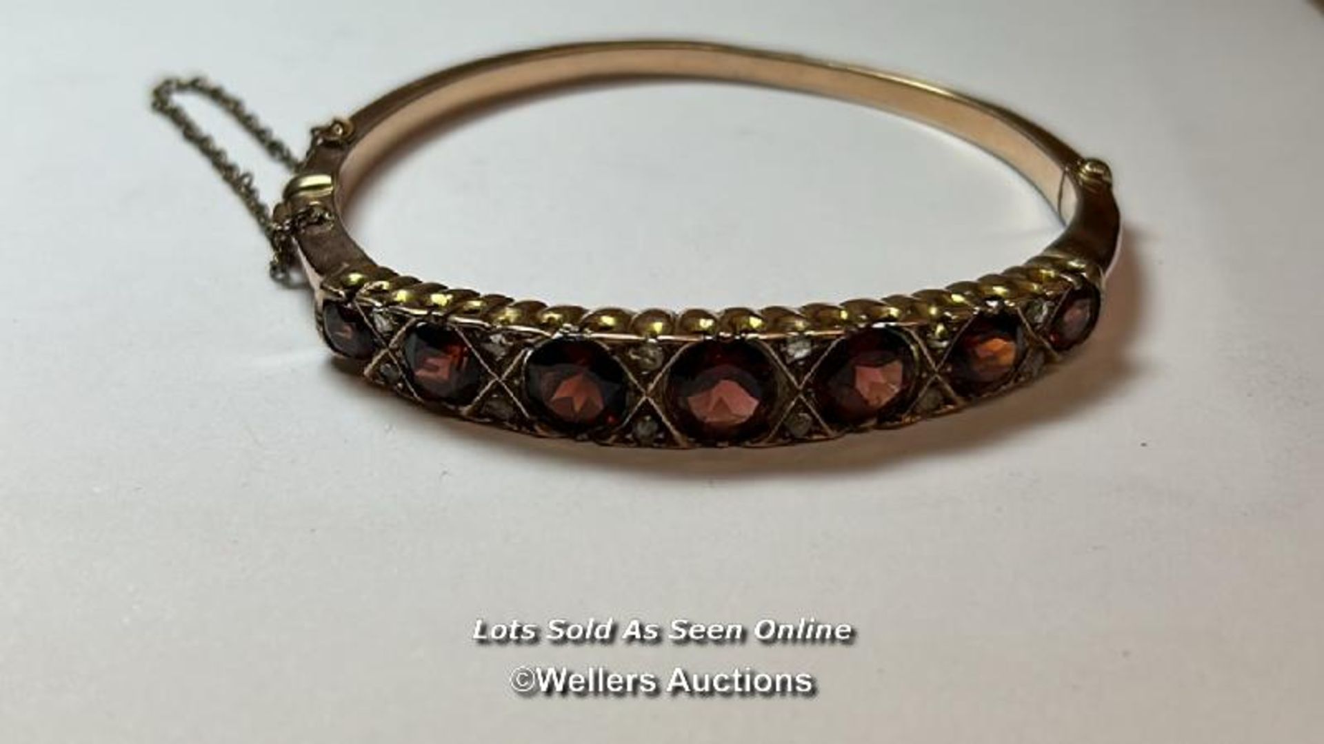 Antique 9ct gold hinged bangle set with garents and rose cut diamonds, with safety chain. Gross - Bild 3 aus 4