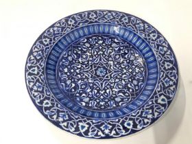 A hand painted glazed pottery plate signed 'Firca (Ottoman) Ismail', 31.5cm diameter / AN4