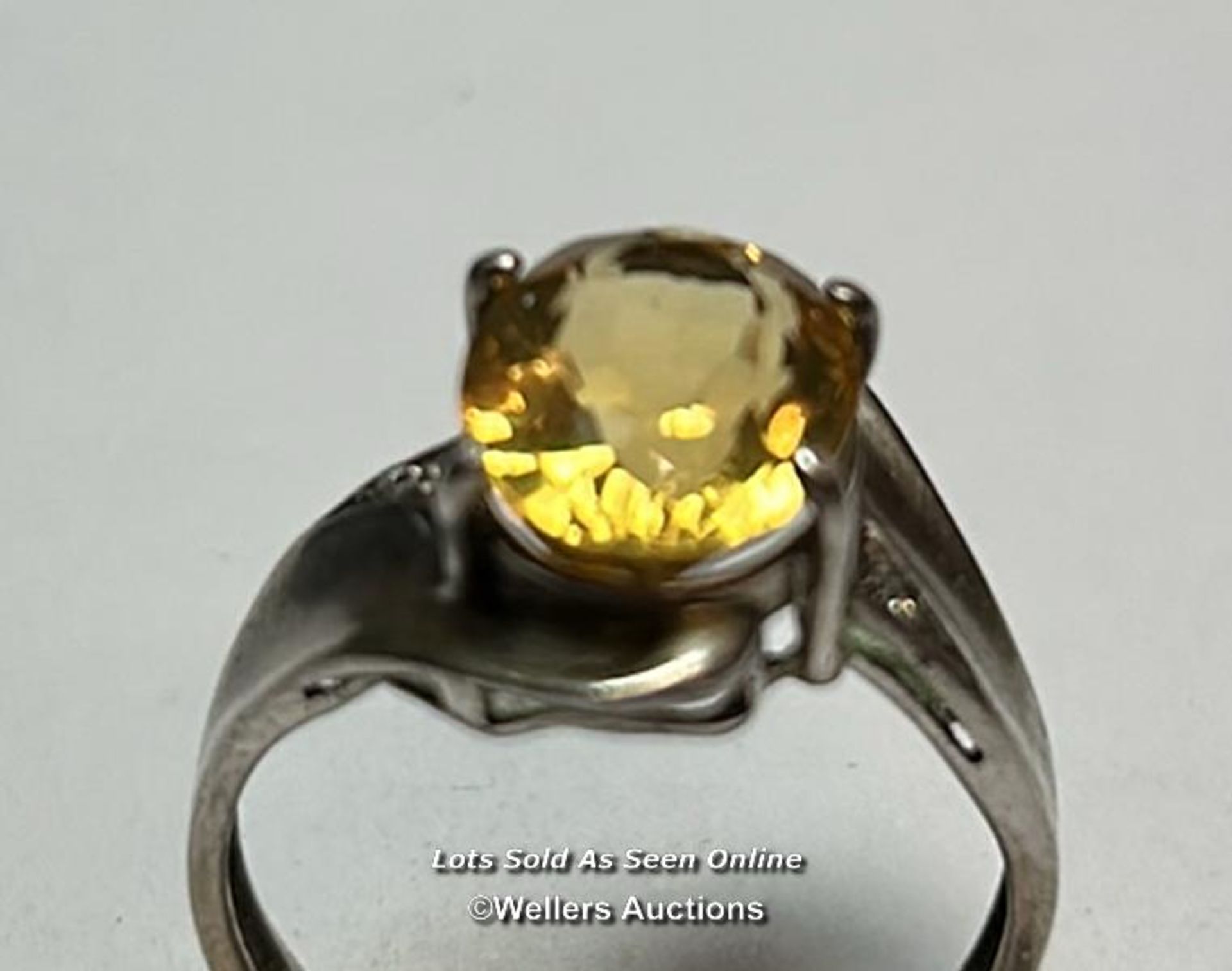 Hallmarked silver ring set with an ovel citrine and cubic zirconia detail on shoulders. Ring size, O