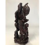 A carved hardwood figure of a fisherman and child, 30cm high / AN3