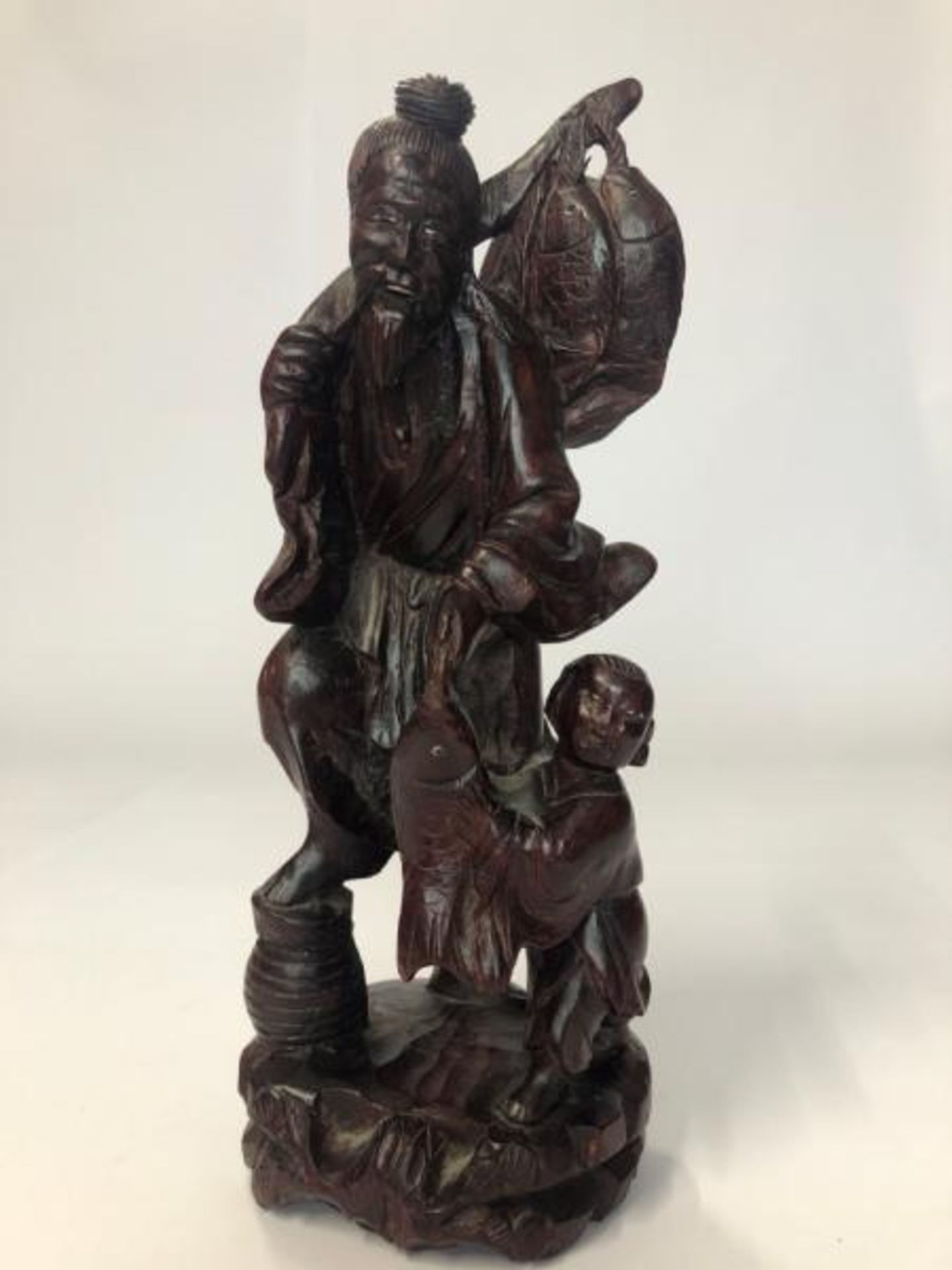 A carved hardwood figure of a fisherman and child, 30cm high / AN3