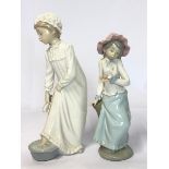 Two Lladro Nao figurines "Girl Takes a Footbath" and "Girl Holding Dove", tallest 28cm high / AN7