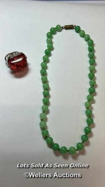 Green glass bead necklace, string knotted to base metal barrel clasp. Length 40cm, with a plastic