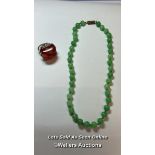 Green glass bead necklace, string knotted to base metal barrel clasp. Length 40cm, with a plastic