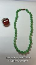 Green glass bead necklace, string knotted to base metal barrel clasp. Length 40cm, with a plastic