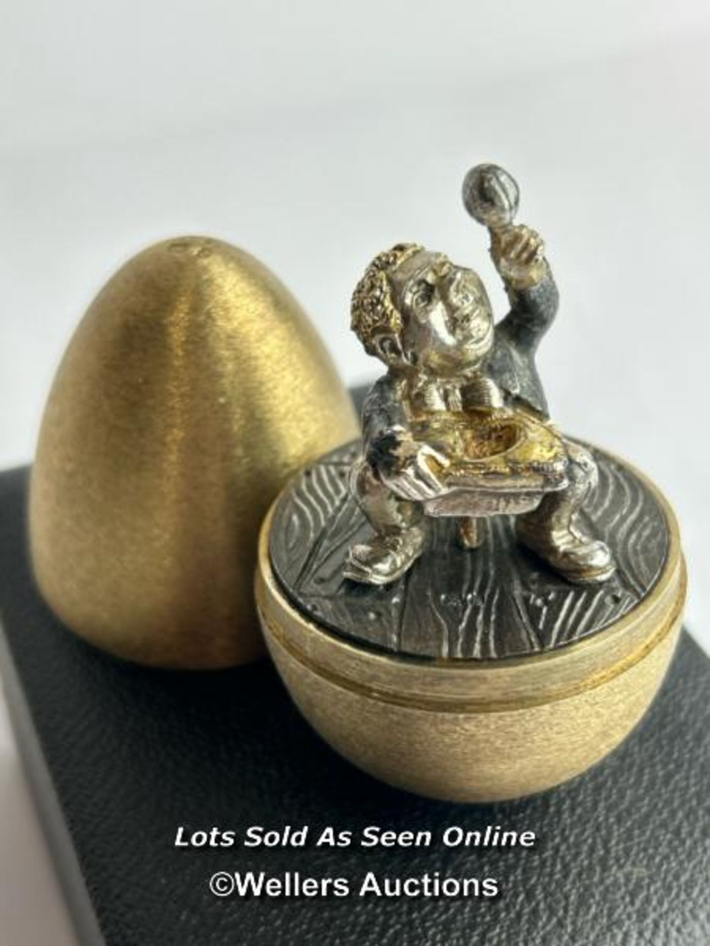 A hallmarked silver gilt egg Stuart Devlin, London 1973, nursery rhyme collection.Opening to