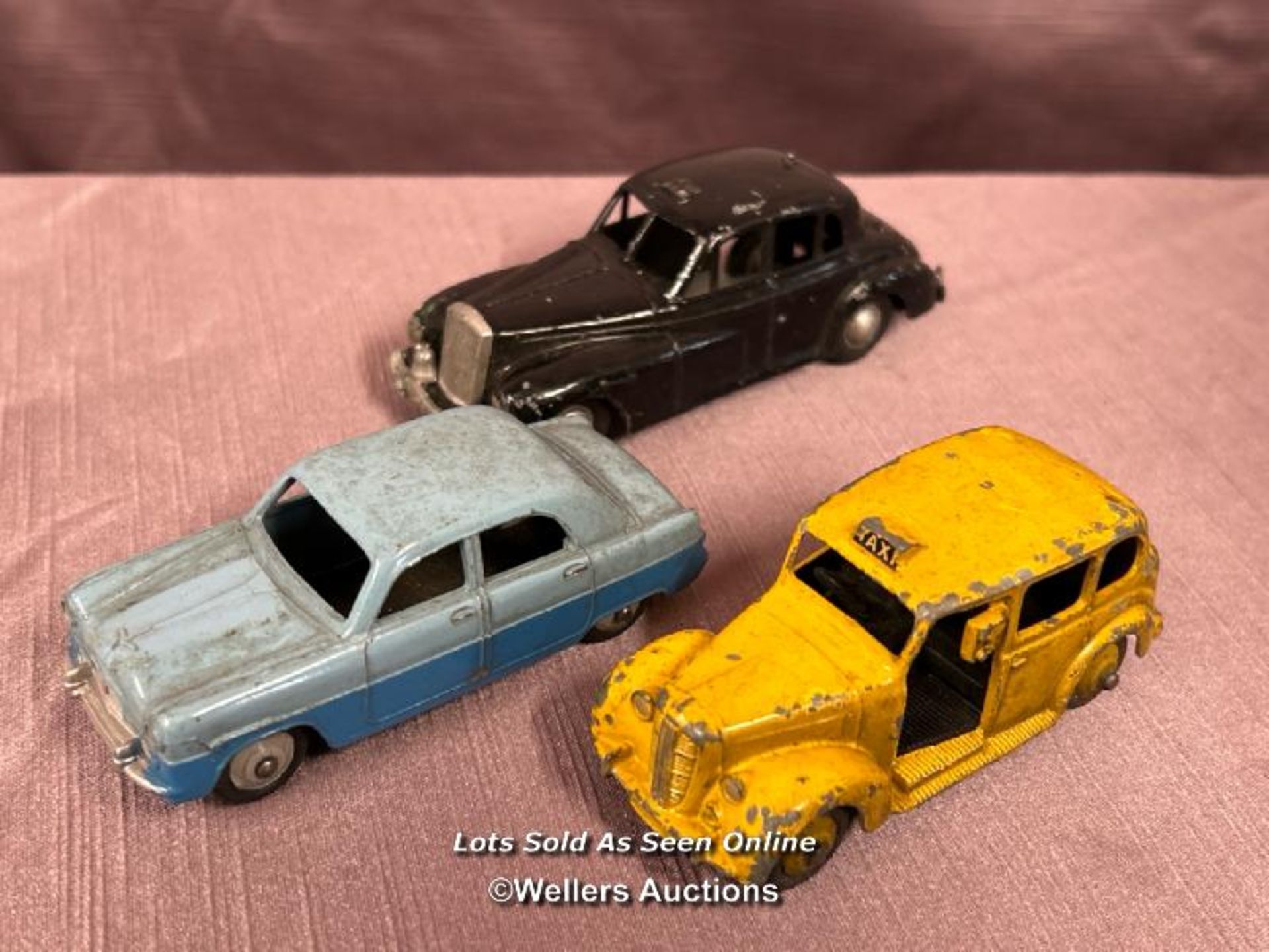 THREE DIE CAST CARS INCLUDING DINKY FORD ZEPHYR NO. 162, DINKY AUSTIN TAXI AND WOLSELEY 60-80