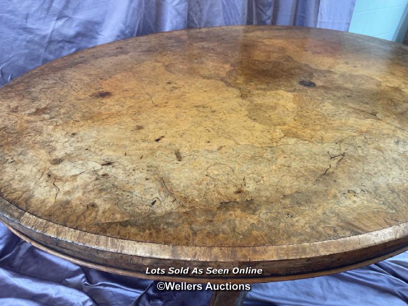 OVAL WALNUT CENTRE TABLE ON SOLID COLUMN BASE WITH FOUR DECORATIVE LEGS AND CASTORED FEET (IN NEED - Image 7 of 10