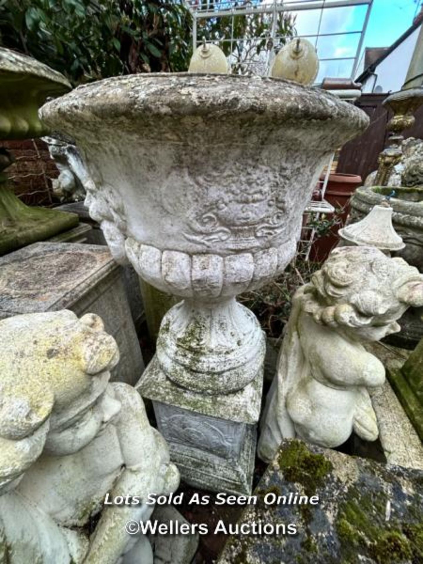 PAIR OF COMPOSITION STONE URN PLANTERS ON ASSOCIATED PLINTHS. THIS LOT IS LOCATED AWAY FROM THE