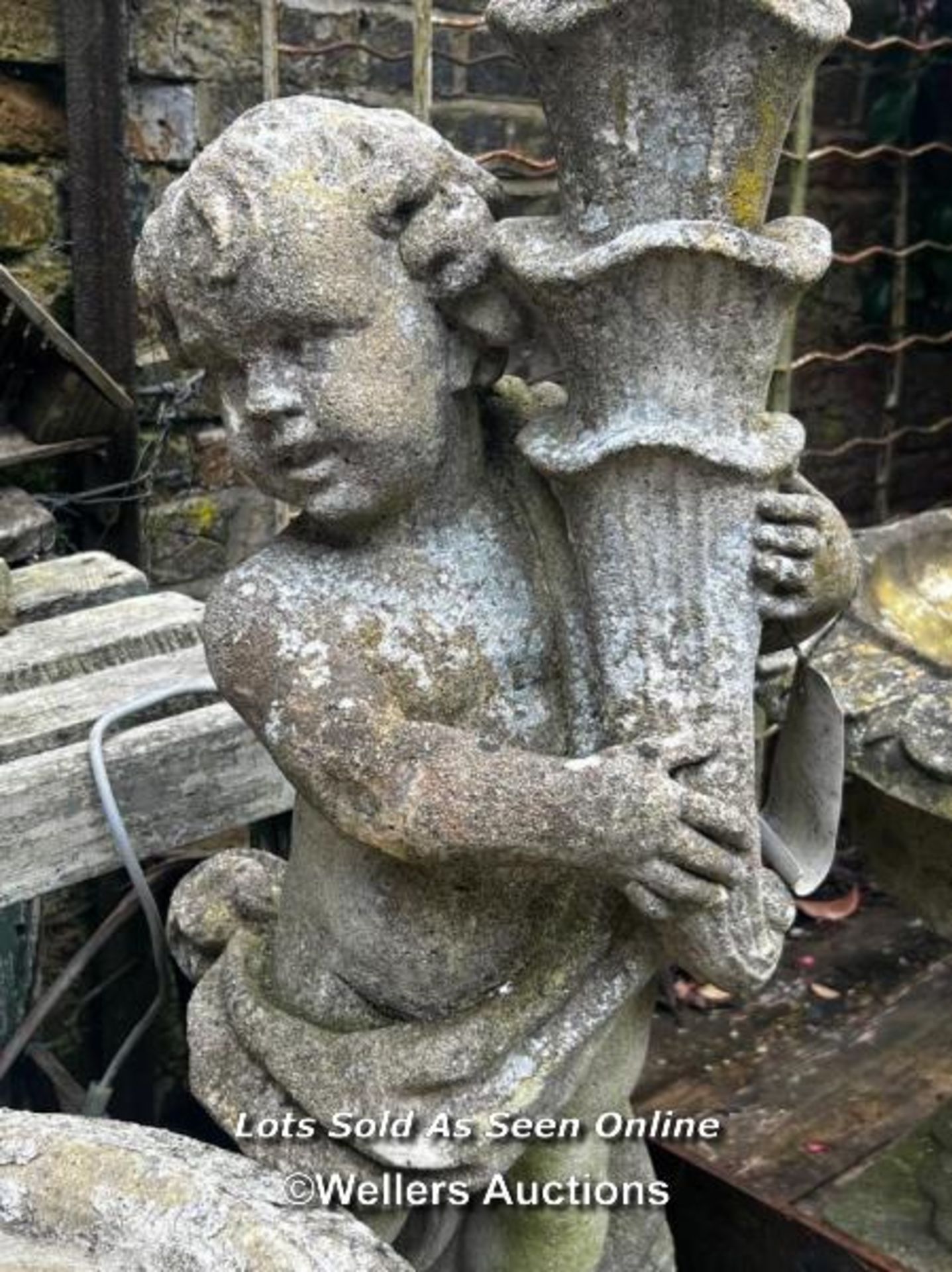 COMPOSITION STONE CHERUB SUPPORTING CORNUCOPIA, PREVIOUSLY ILLUMINATED, THIS LOT IS LOCATED AWAY