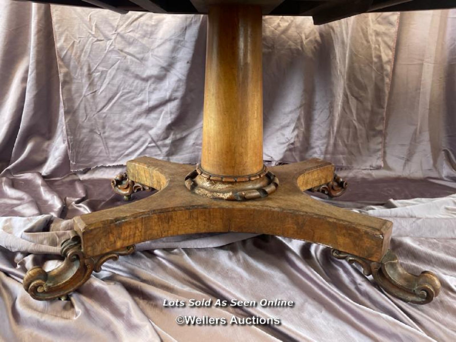 OVAL WALNUT CENTRE TABLE ON SOLID COLUMN BASE WITH FOUR DECORATIVE LEGS AND CASTORED FEET (IN NEED - Image 3 of 10