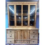 LARGE STRIPPED PINE DRESSER WITH FOUR GLAZED DOORS ON TOP OVER TWO DOORS BELOW AND SIX DRAWERS,