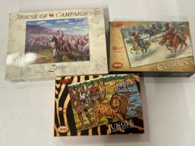 Three opened, unmade model kits including Zulus, Jungle Adventure and Cossacks / AN20
