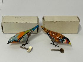 Two vintage tinplate wind up birds, both in good working order with keys and plain white boxes /