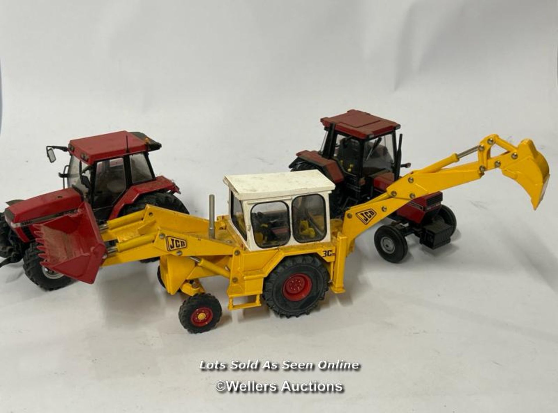 Britain's JCB digger no. 42905 with two model tractors / AN4