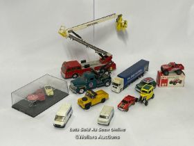 Assorted model vehicles including boxed Tomy Toyota Hilux Bigfoot, Corgi fire truck, Tesco truck and