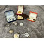 Three open face pocket watches, two with watch chains, a pendant watch on chain, a silver napkin