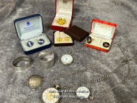 Three open face pocket watches, two with watch chains, a pendant watch on chain, a silver napkin
