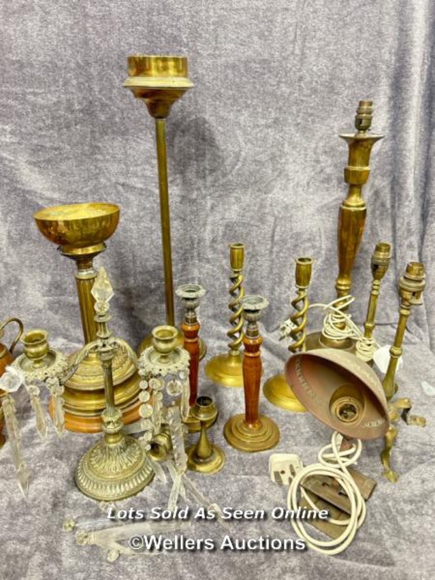 Collection of brass lamps and candle holders including a pair of twisted candle sticks, vintage desk