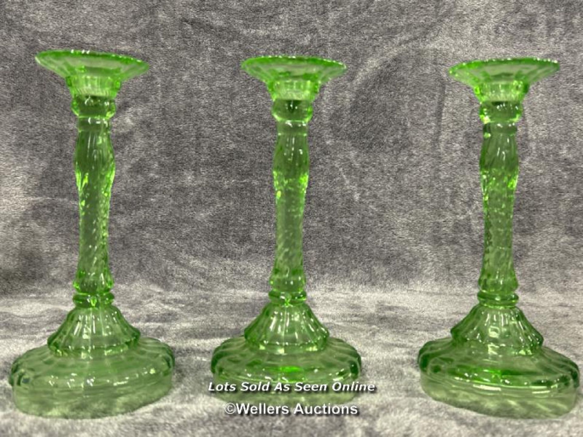 Three green uranium glass candle holders, each 24.5cm high / AN6