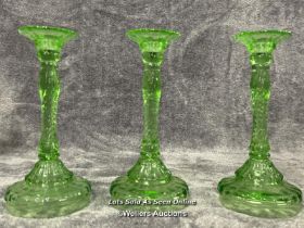 Three green uranium glass candle holders, each 24.5cm high / AN6