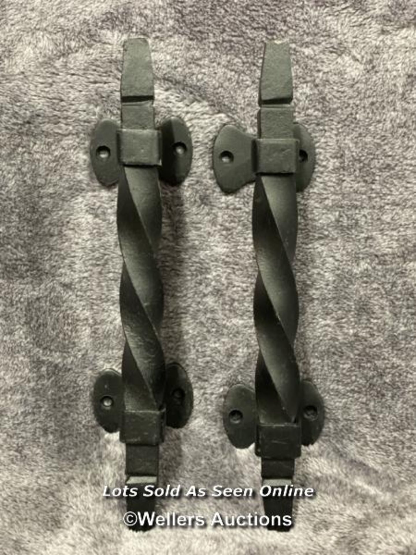 A pair of iron door pull handles in twist design, 28cm long