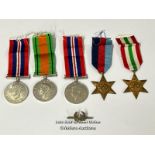 Four medals including the Italy star and the 1939-1945 star with a military cap badge stamped Silver