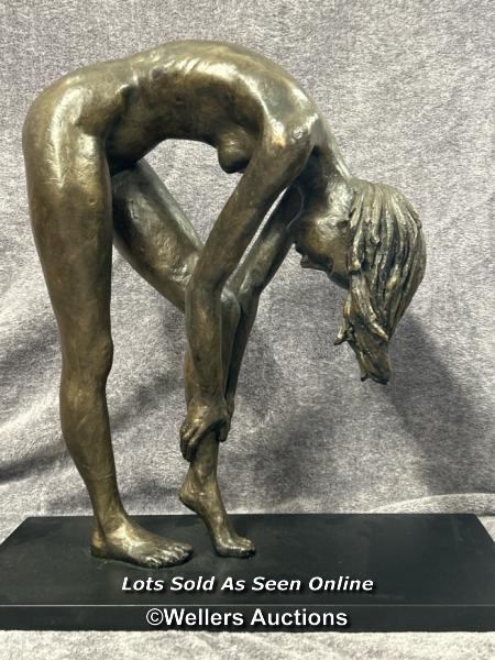 A large bronze effect resin study of a nude female on wooden base, numbered 5/95, 50cm high / AN1