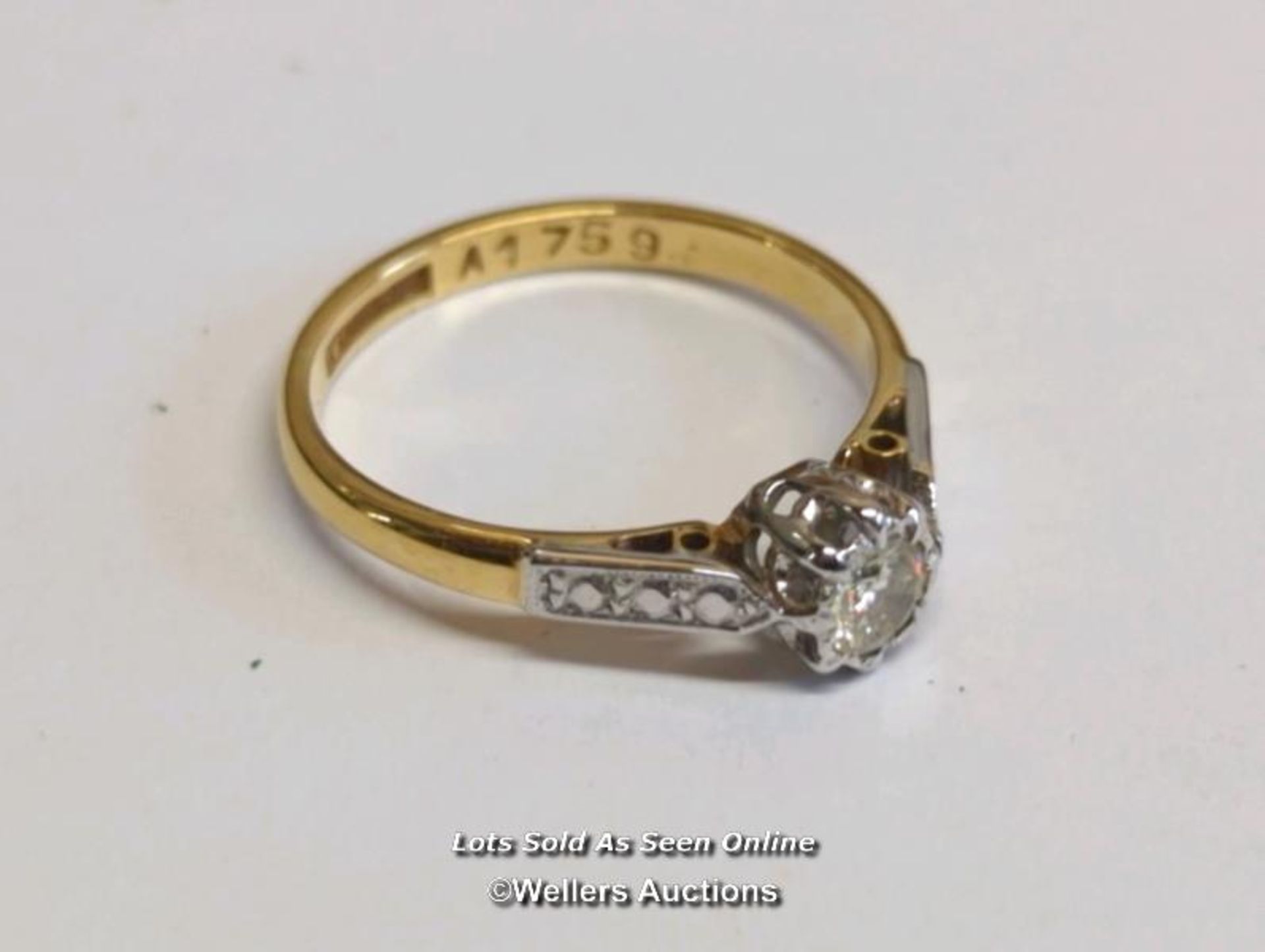 A diamond solitaire ring, the diamond illusion set in a mount stamped 18ct and platinum, ring size M