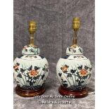 Pair of ceramic table laps, decorated with flowers on wooden base with lamp shades, both need plugs,