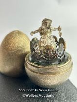 A hallmarked silver gilt egg Stuart Devlin, London 1973, nursery rhyme collection. Opening to reveal