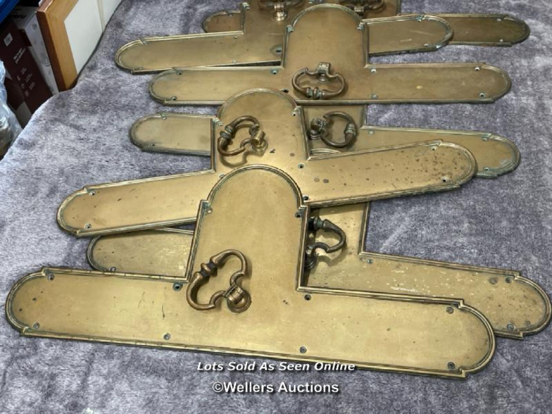 A collection of eight brass door pull handles, mounted on shaped back plates, five with key holes, - Image 2 of 5