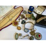 Bag of assorted costume jewellery, mostly brooches, a hinged bangle stamped gold on silver, a gold