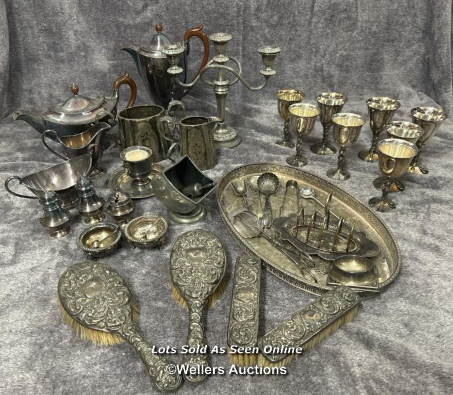 A large collection of antique metal plated items including a three armed candelabra, goblets,