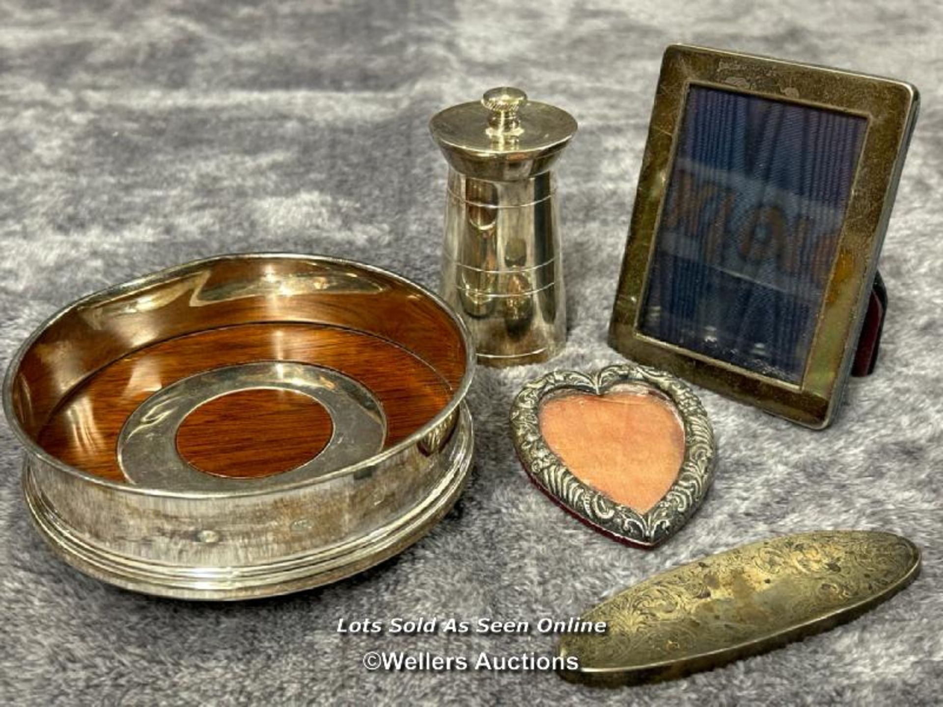 A selection of hallmarked silver items, including pepper grinder, heart shaped frame, dish and