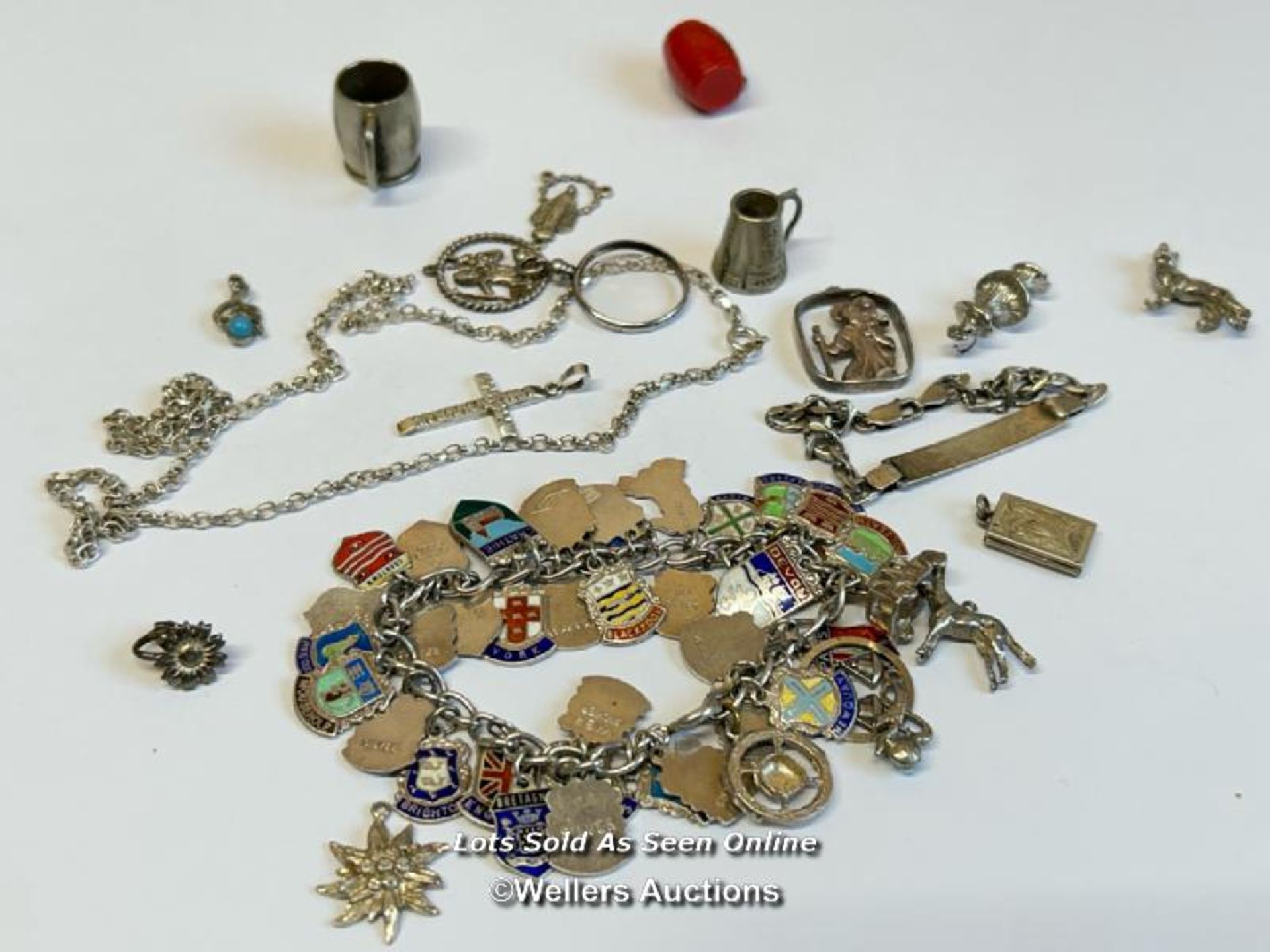 Silver charm bracelet with thirty-eight mostly souvenir charms, along with a silver chain and