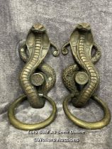 A pair of plaster bronze effect cobra door handles, 46cm high