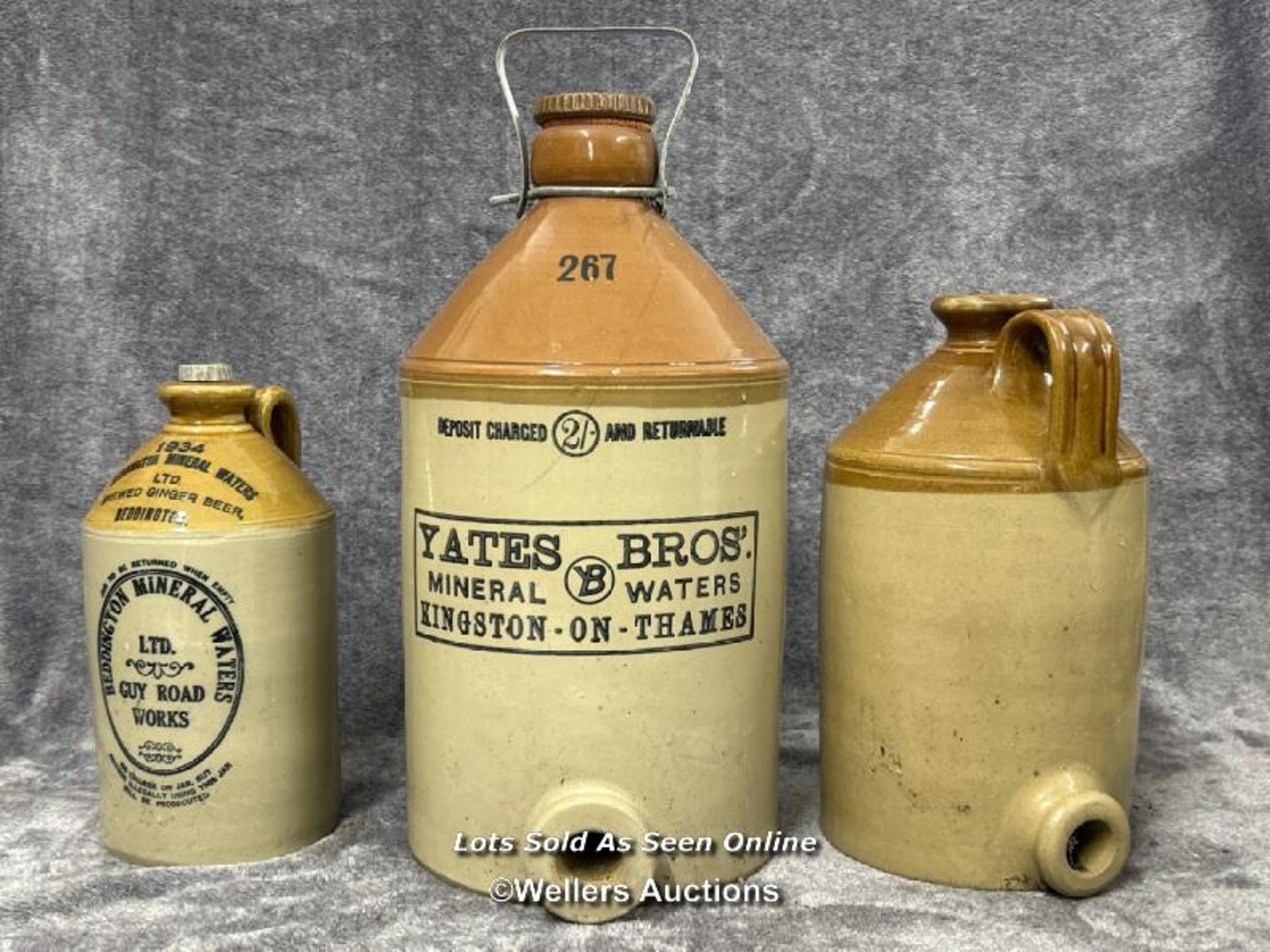 Three glazed stoneware bottles including a large vintage Yates Bros Mineral Water bottle, 43cm high,