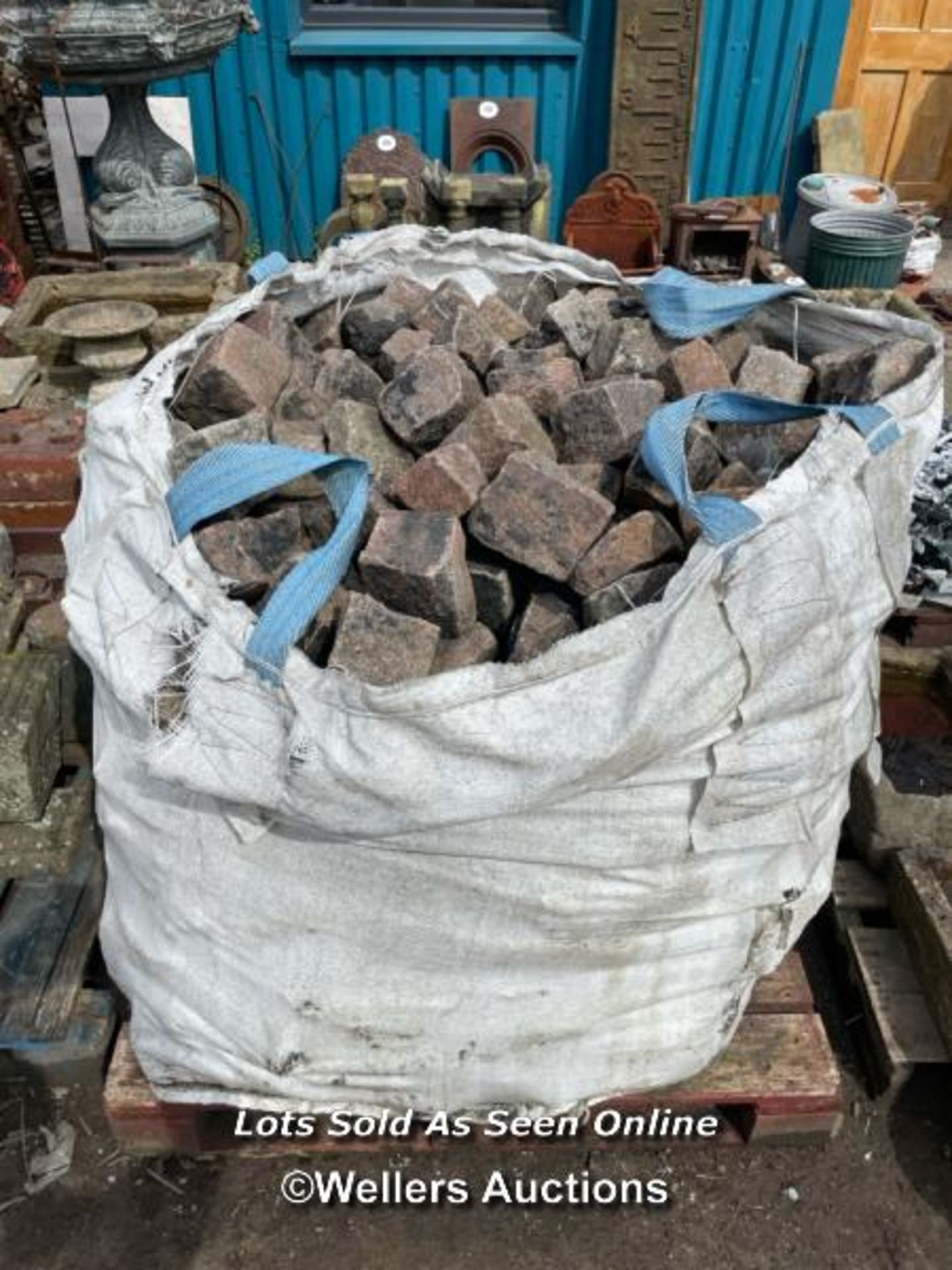 *A TONNE BAG OF RED GRANITE SETTS