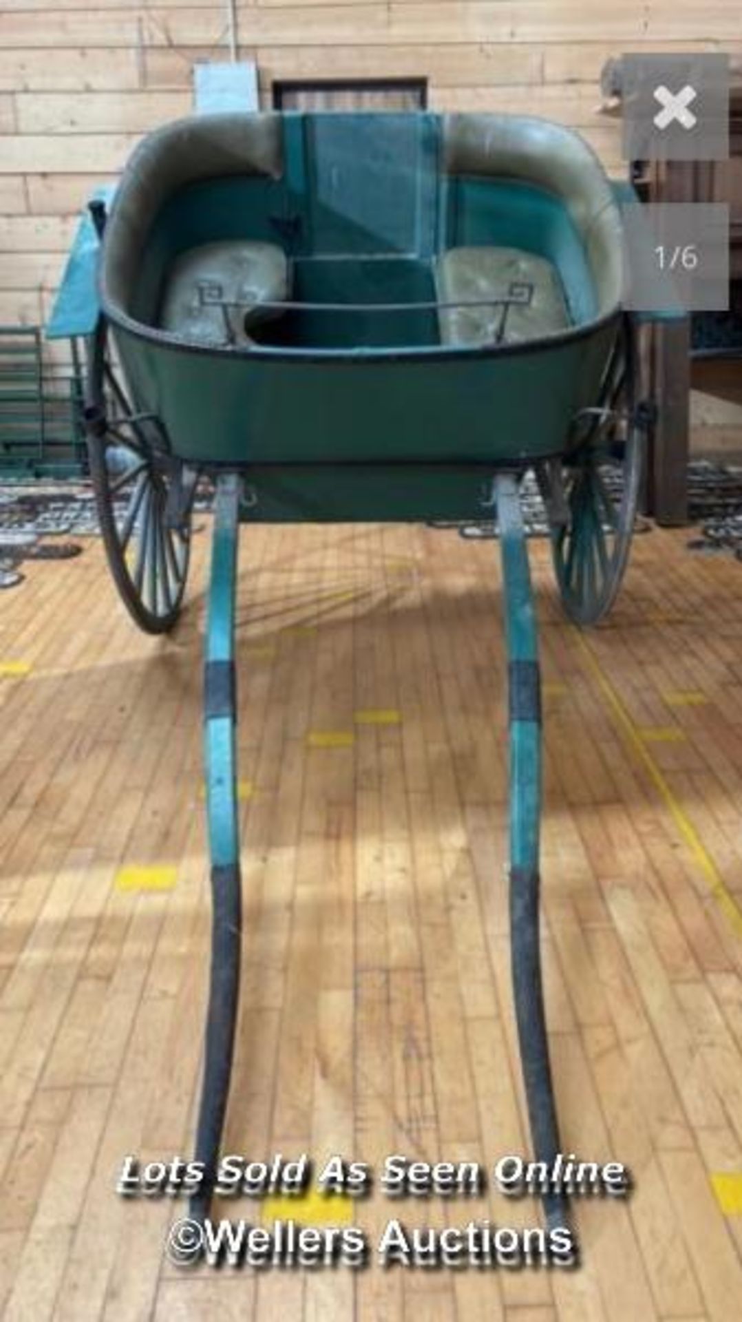 *A VINTAGE TWO MAN HORSE CART WITH GREEN LEATHER CUSHIONED SEATING AND BACKREST, ON TWO WHEELS