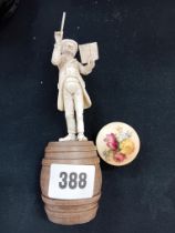 BONE FIGURE OF MAESTRO ON WOODEN BARREL